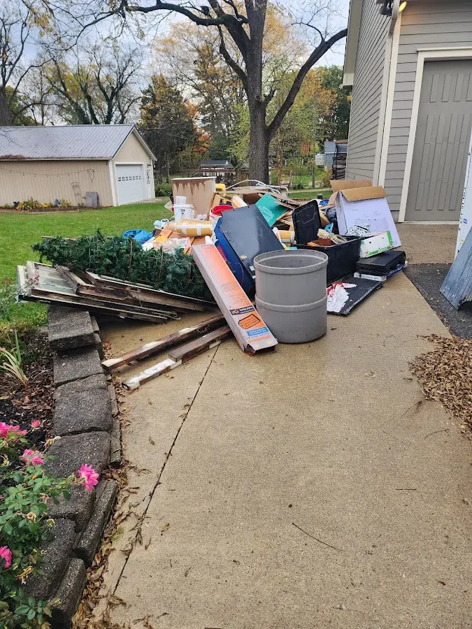 Dumpster being loaded with debris for Estate Cleanout Dumpster Rental in National Harbor